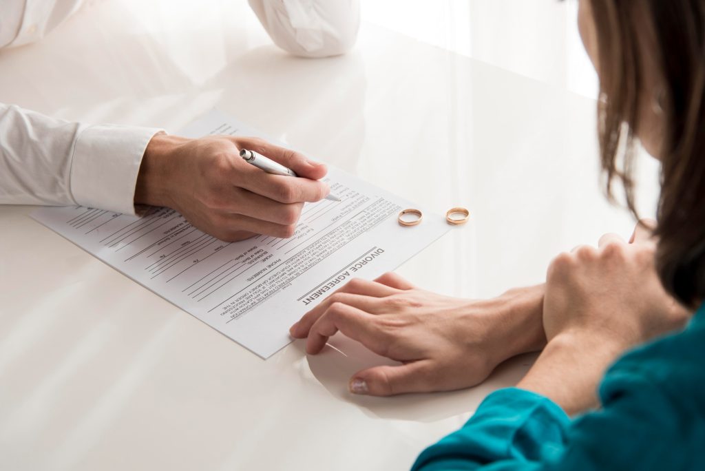 Person reviewing divorce agreement documents while discussing assets in a Colorado divorce and property division.