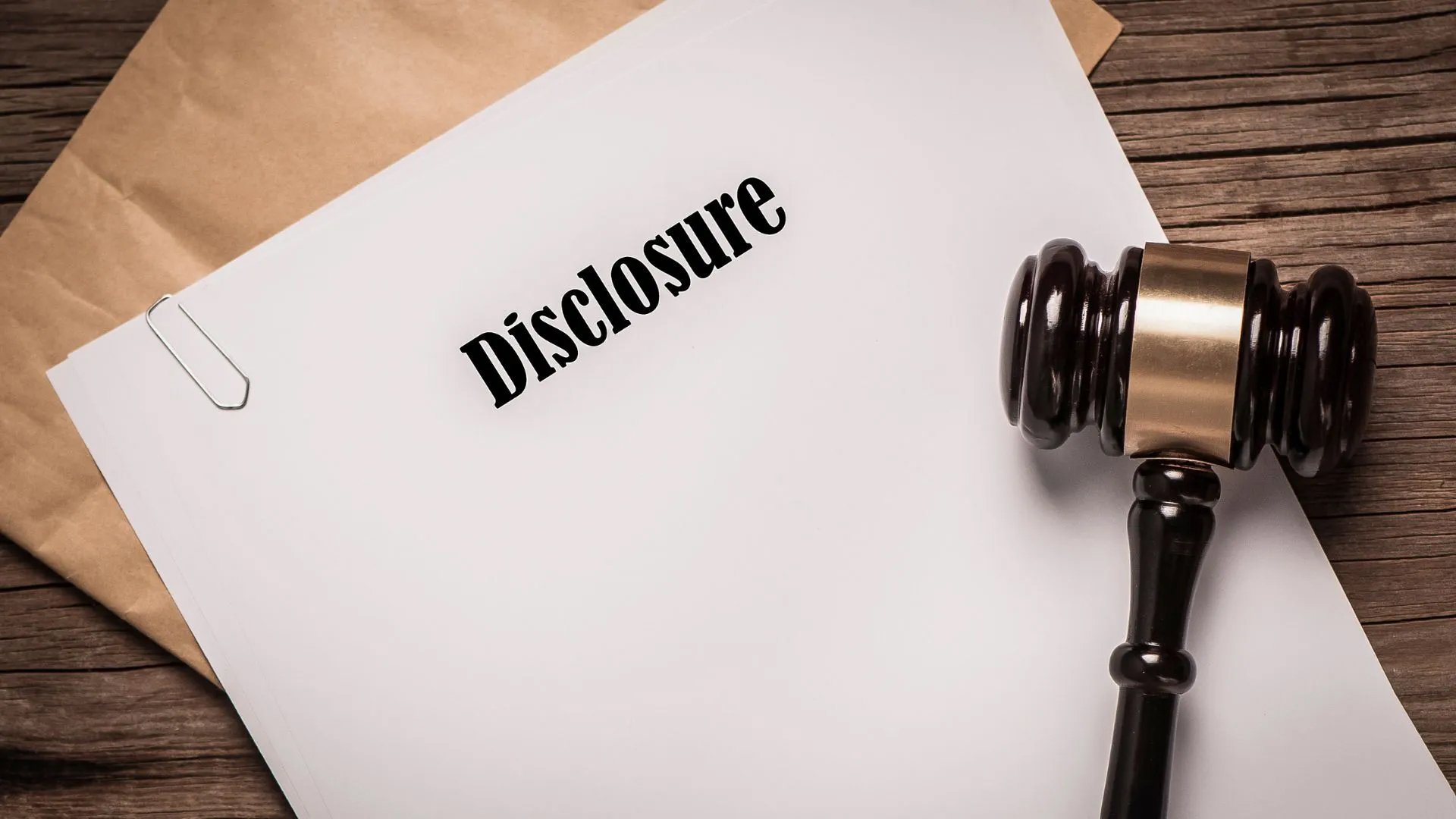 Legal disclosures and a judge’s gavel, highlighting the mandatory documentation required when determining how long a divorce takes