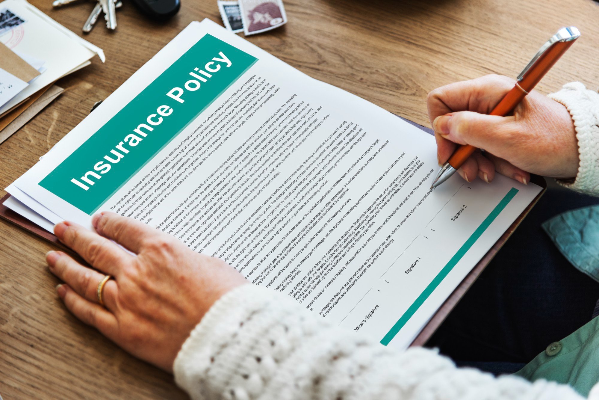 Close-up of insurance policy terms and agreement paperwork, representing the administrative steps required during a divorce process