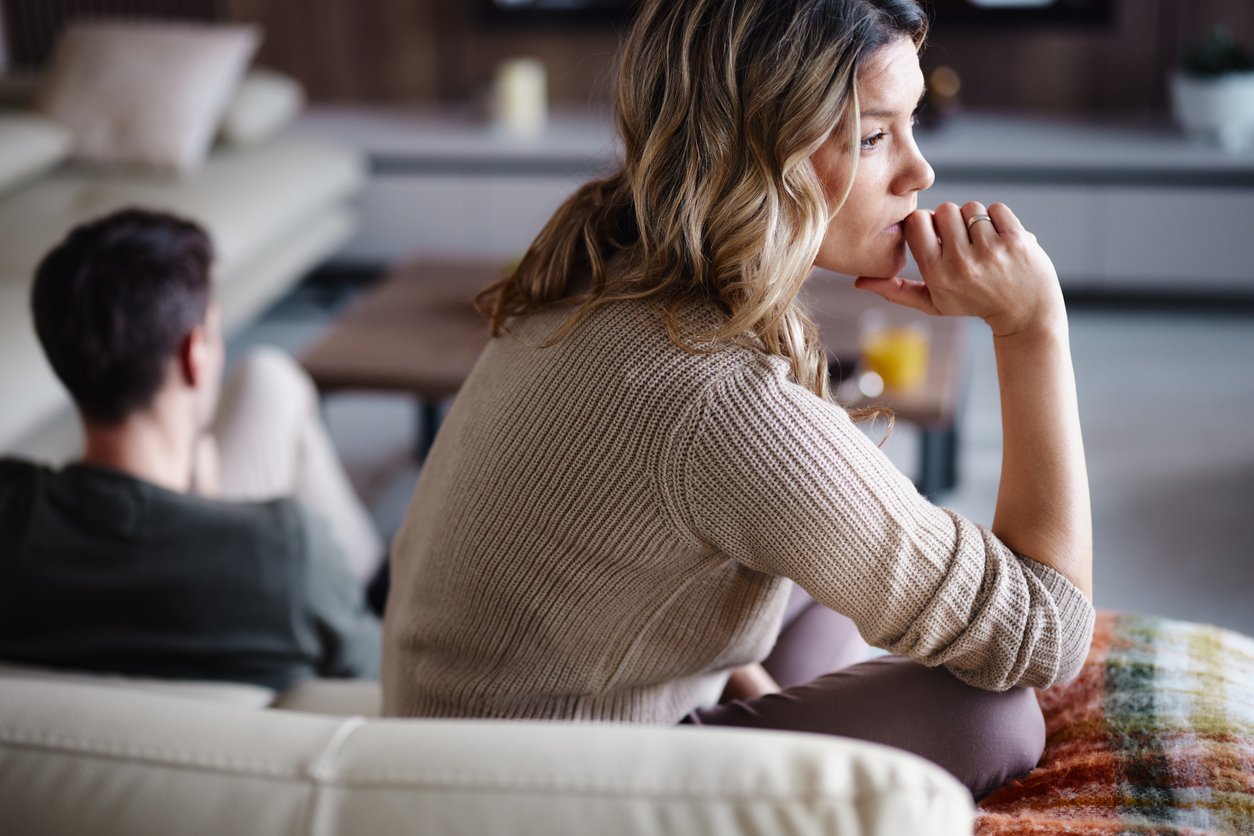 Woman reflecting during a difficult conversation about assets in a Colorado divorce and property division.