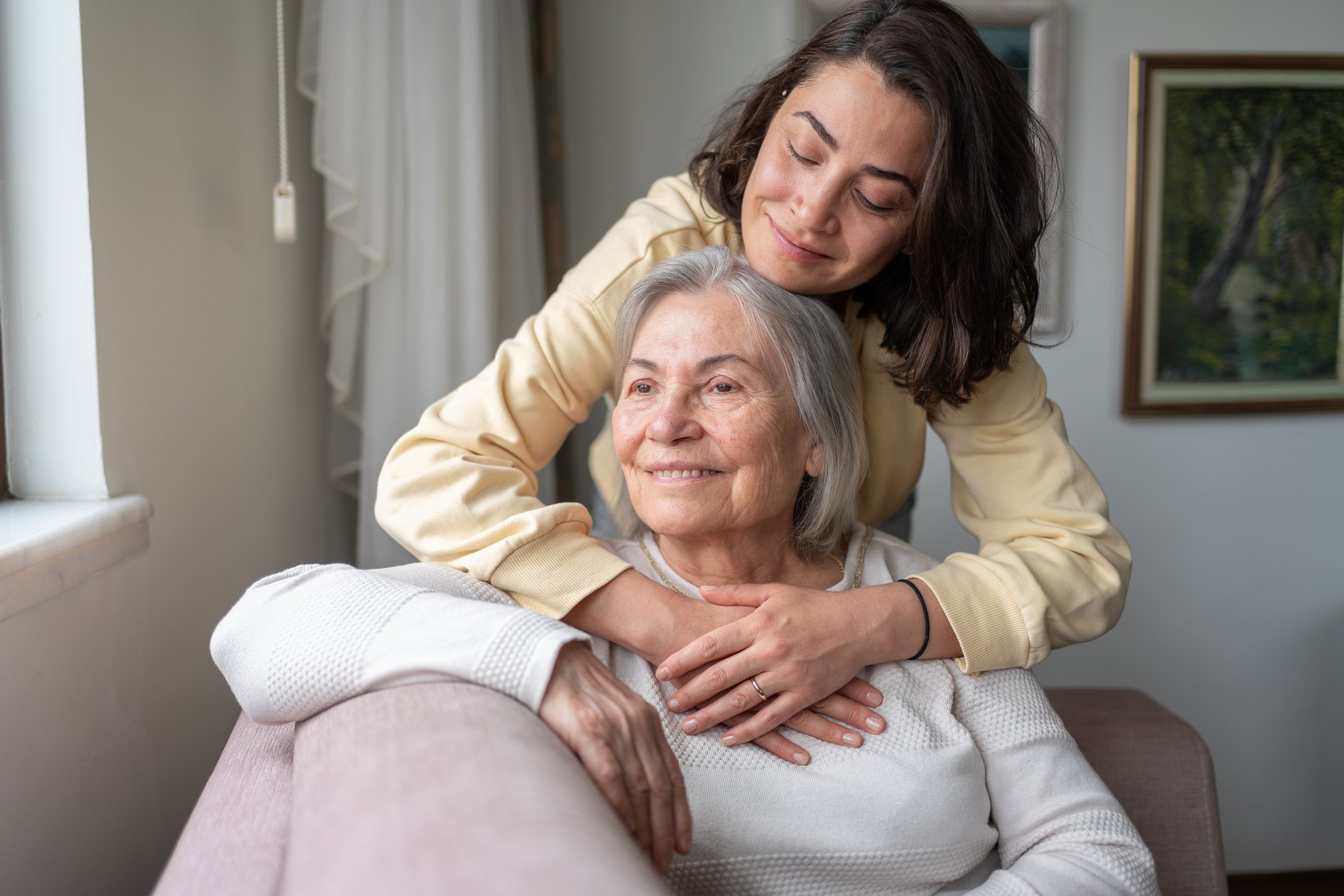 A daughter hugging her senior mother in a loving bond, representing the sense of security and care provided by a parents' estate plan
