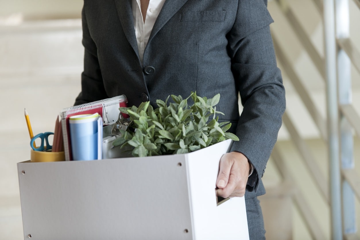 Businesswoman holding a storage box of documents while preparing for a comprehensive estate plan review
