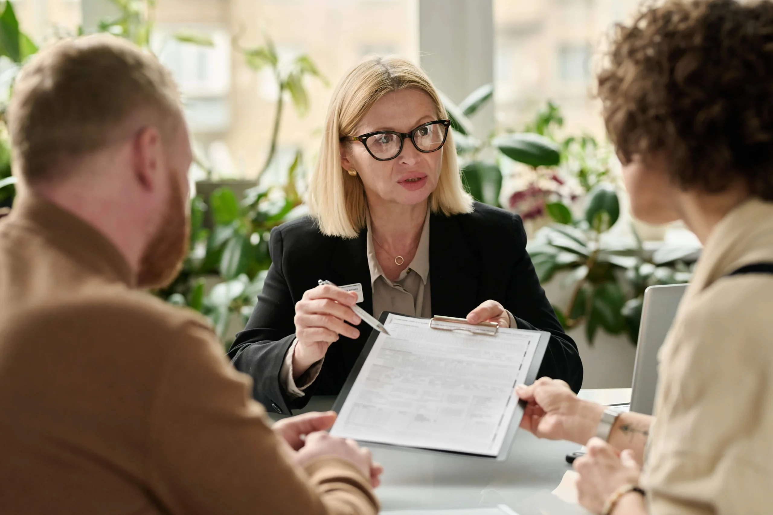 Woman handing contract to coupe