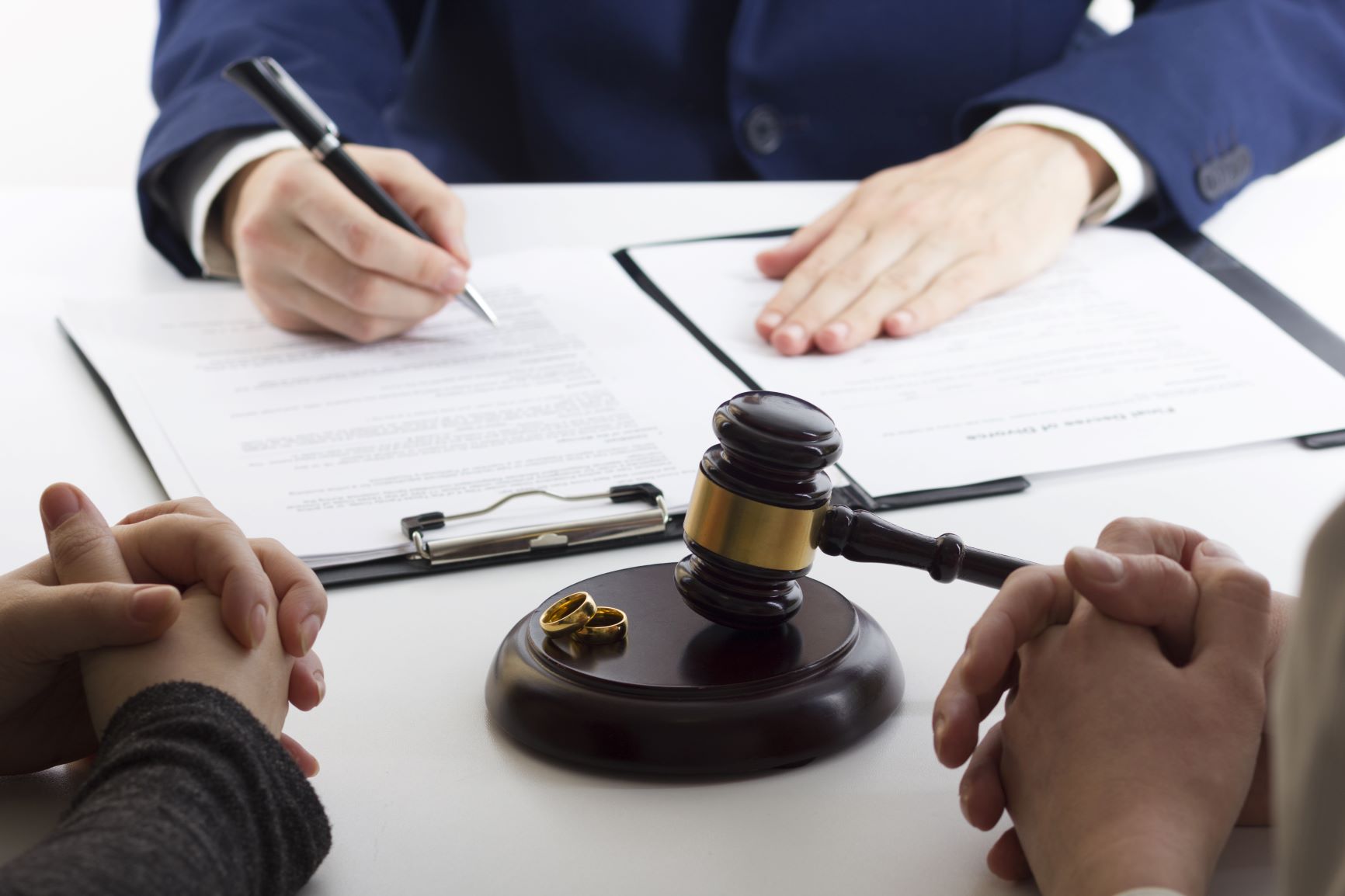 Husband and wife signing premarital agreement prepared by lawyer